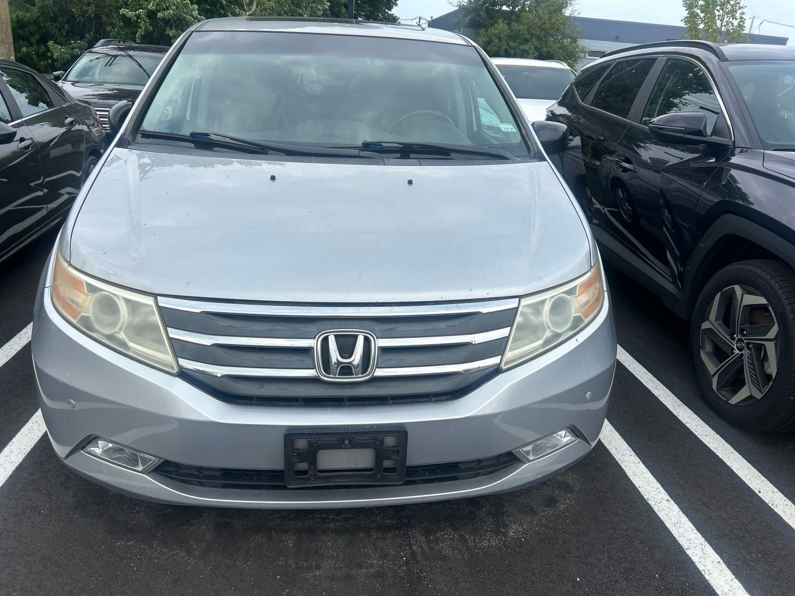 2012 Honda Odyssey Touring in Alabaster Silver Metallic — front three-quarter view