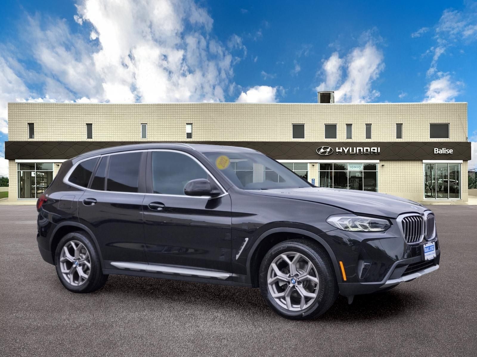 2022 BMW X3 xDrive30i in Black Sapphire Metallic — front three-quarter view